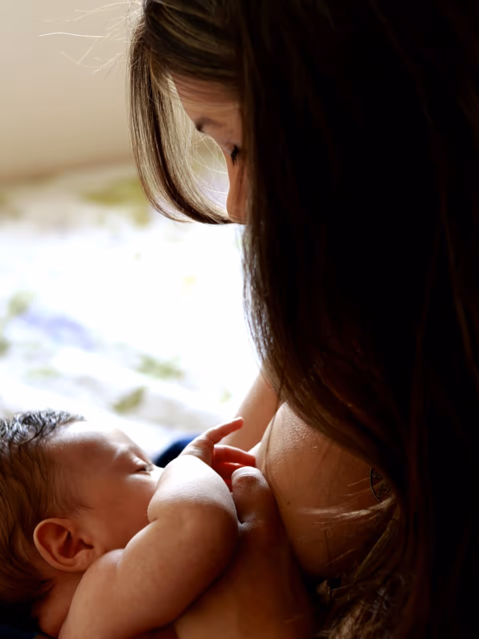 A mother breastfeeding her newborn